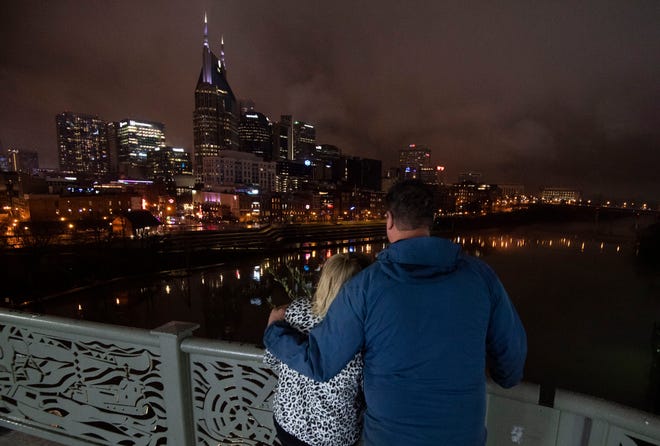 Second Ave. residents and bombing survivors Linda Ingram and Colby Childs hug each other as they look at the skyline after a Ceremony of Reflection for the 2020 Christmas Day Bombing on 2nd Ave. Thursday, Dec. 16, 2021 in Nashville, Tenn. 