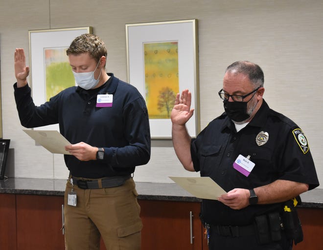 Lorenzo Shepler (left) and Matt Reed take their oaths to become Reid Health Police Department officers.