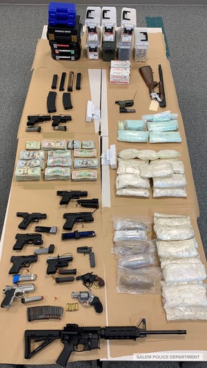 Methamphetamine, heroin, pills, cash and guns seized by Salem police.