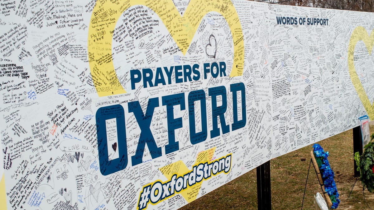 Handwritten messages are left at the memorial site outside Oxford High School in Oxford, Michigan.