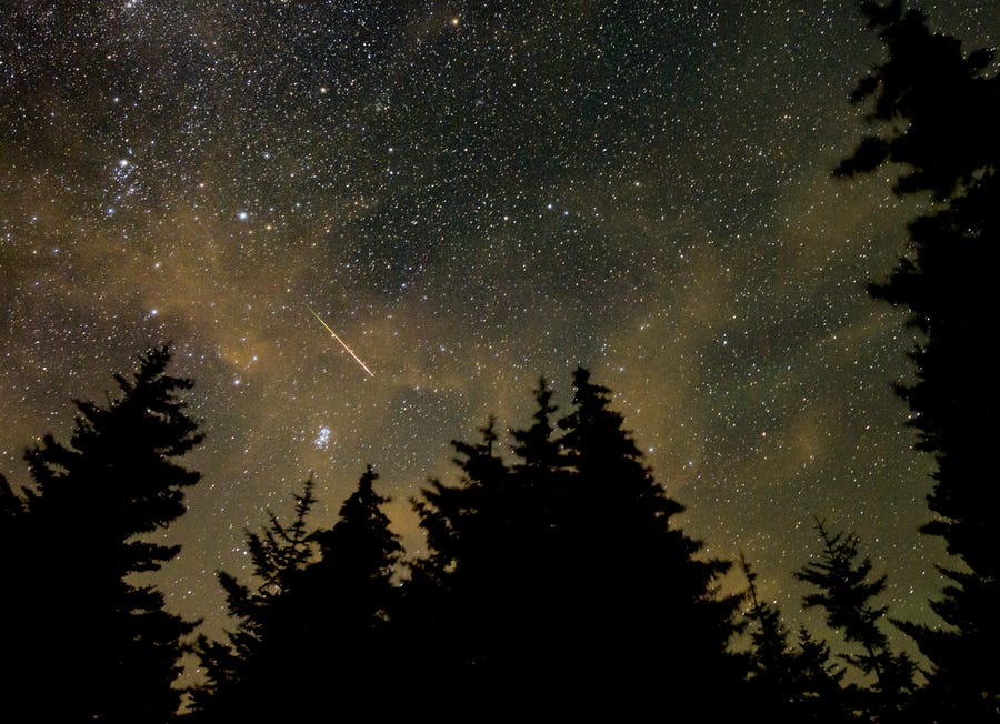 A meteor streaks across the sky during the annual Perseid meteor shower Aug. 11 in Spruce Knob, W.Va.