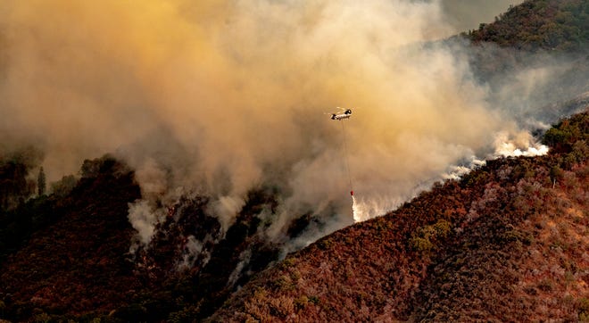 Helicopters dump river water on the KNP Complex Fire as seen from Amphitheater Point in Sequoia National Park on Monday, September 13, 2021. 