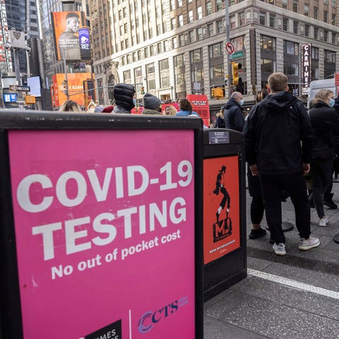 People wait in line to get tested for COVID-19 at 