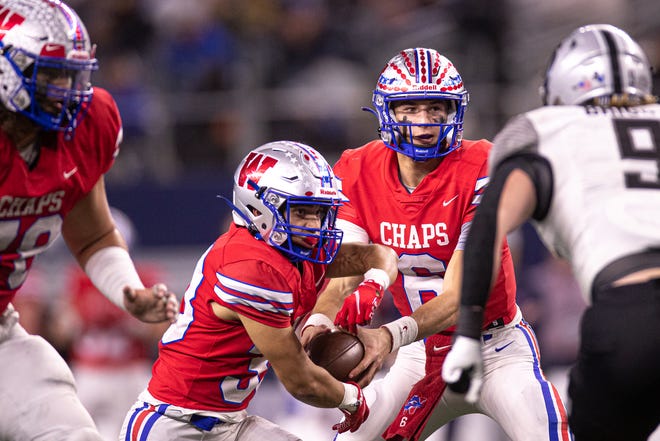 Westlake quarterback Cade Klubnik (6) hands the ball to running back Jackson Kayser (33) during the Class 6A Division 2 State Championship against Guyer at AT&T Stadium in Arlington, Texas on Dec. 18, 2021. Westlake defeated Guyer 40-21.
