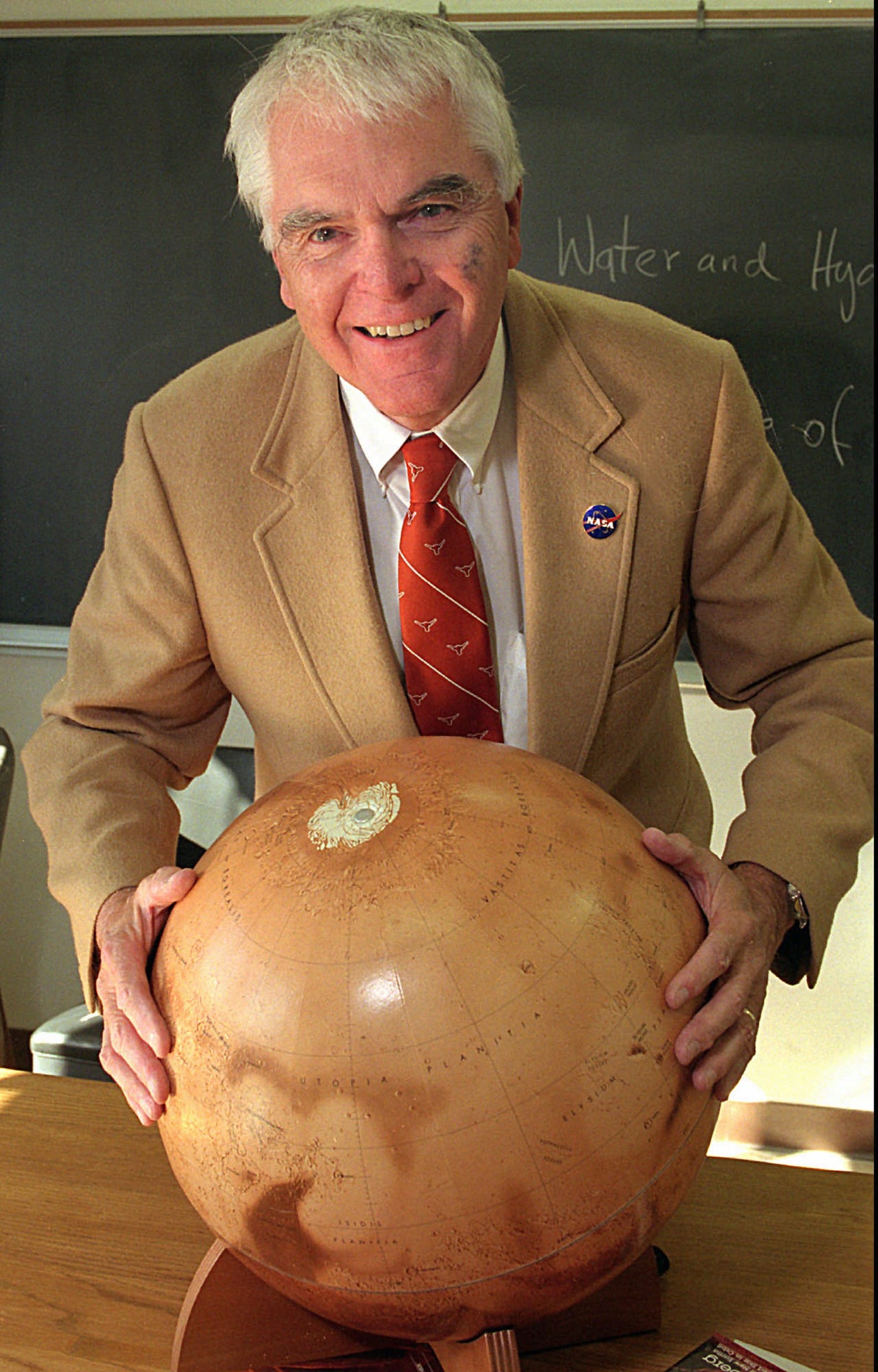 Hans Mark with replica of the planet Mars.