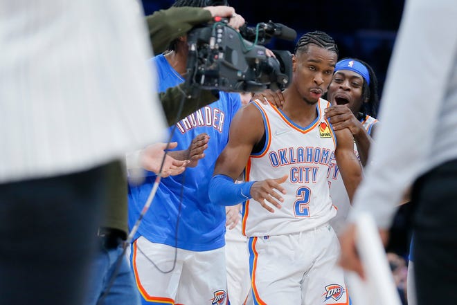 Thunder guard Shai Gilgeous-Alexander (2) celebrates in front of Luguentz Dort (5) after making the game-winning shot against the Clippers on Dec. 18 at Paycom Center.