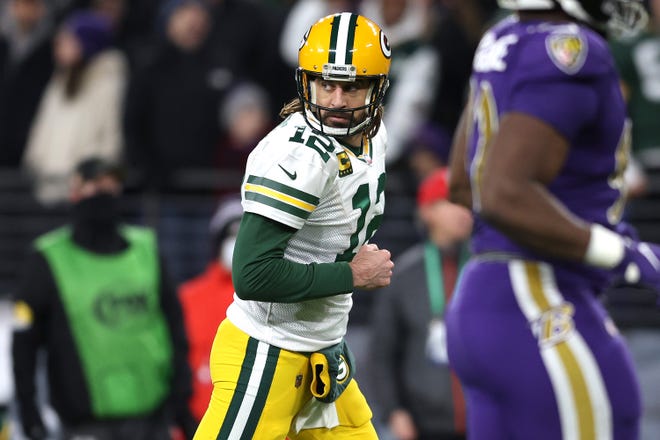 Aaron Rodgers pumps his fist after throwing for a third quarter touchdown against the Baltimore Ravens on Sunday, Dec. 19, 2021, at M&T Bank Stadium in Baltimore.
