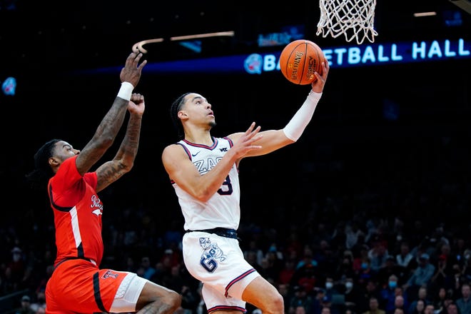 Gonzaga guard Andrew Nembhard, right, goes up for a shot against Texas Tech guard Davion Warren, left, during the first half of an NCAA college basketball game at the Jerry Colangelo Classic Saturday, Dec. 18, 2021, in Phoenix. (AP Photo/Ross D. Franklin)