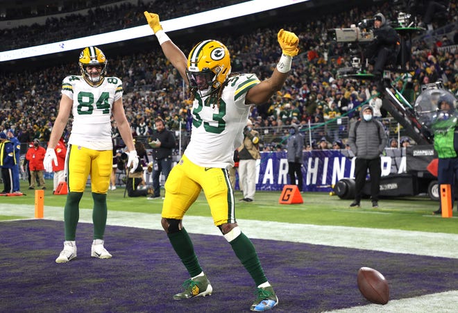 Aaron Jones #33 of the Green Bay Packers celebrates after his touchdown reception in the third quarter against the Baltimore Ravens at M&T Bank Stadium on December 19, 2021 in Baltimore, Maryland.