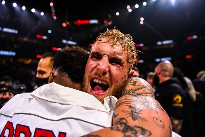 YouTube personality Jake Paul celebrates after knocking out former UFC welterweight champion Tyron Woodley during a fight at the Amalie Arena in Tampa, Florida, on December 18, 2021.