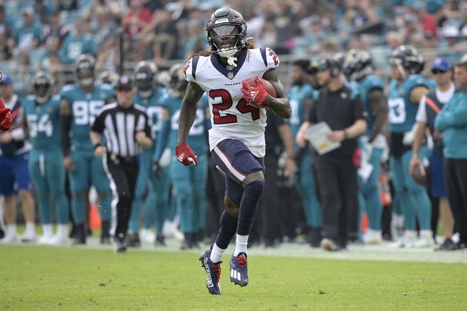 Houston Texans' kick returner Tremon Smith (24) finishes off a 98-yard touchdown during the first half to give his team a 14-3 lead over the Jaguars.