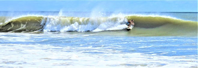 Surfing on St. Augustine Beach on the waves created by offshore Hurricane Larry, the photographer's namesake.