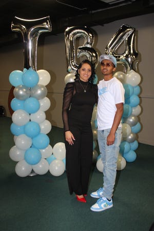 Mia Lee poses for a photo with her son, Tyler Brown, at a 16th birthday party held Sunday, Dec. 19, 2021, for Tyler at Faith Apostolic Church in South Bend. The party also served as a celebration of Brown's recovery after he was seriously injured in an October shooting.