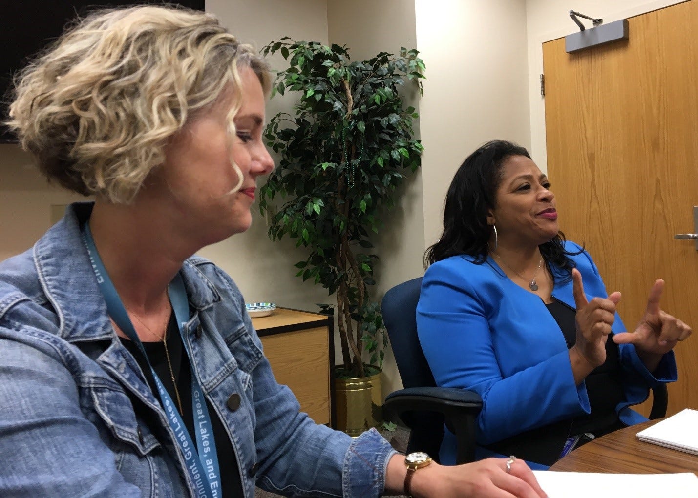 EGLE environmental justice public advocate Regina Strong, right, discusses her new role with EGLE Director Liesl Eichler Clark and others in July 2019.