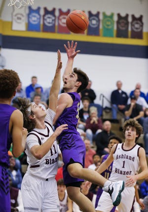 Male's Jack Edelen (5) shot against Ashland Blazer's Colin Porter (11) during their game in the King of the Bluegrass Holiday Classic tournament at the Fairdale High School in Louisville, Ky. on Dec. 19, 2021.