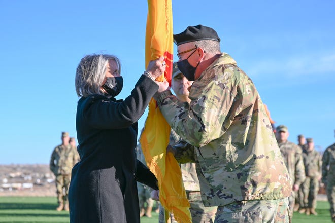 New Mexico Governor Michelle Lujan Grisham congratulates Maj. Gen. Kenneth Nava, the Adjutant General of New Mexico, on his retirement after more than 33 years of military service.