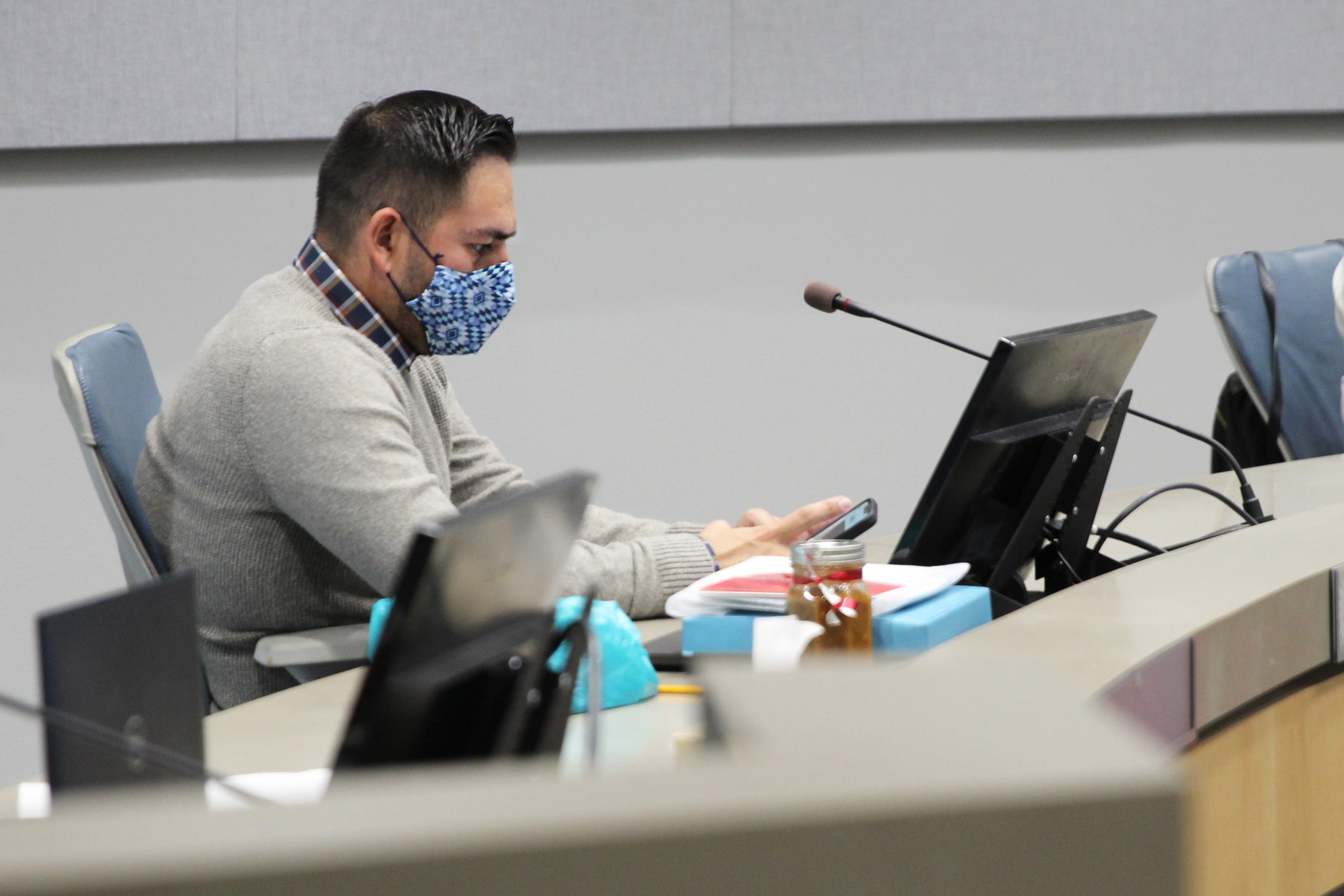 Gabe Vasquez, outgoing city councilor for district 3, checks his phone during his last city council meeting at Las Cruces City Hall on Monday, Dec. 20, 2021. Vasquez chose not to run in the 2021 election.