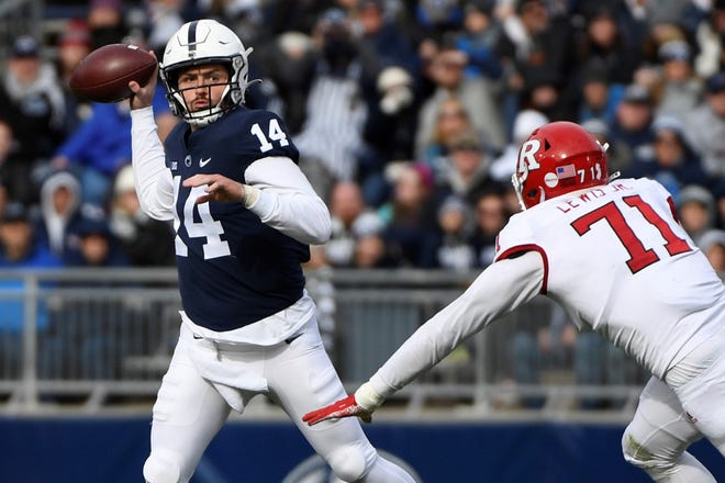 Penn State quarterback Sean Clifford (14) passes while being pressured by Rutgers defensive lineman Aaron Lewis (71) during an NCAA college football game in State College, Pa., Saturday, Nov. 20, 2021. Penn State won 28-0. (AP Photo/Barry Reeger)