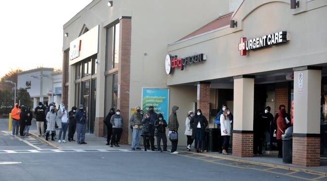 People stand in line to receive Covid-19 tests at AFC Urgent Care in Hartsdale, N.Y. Dec. 20, 2021.