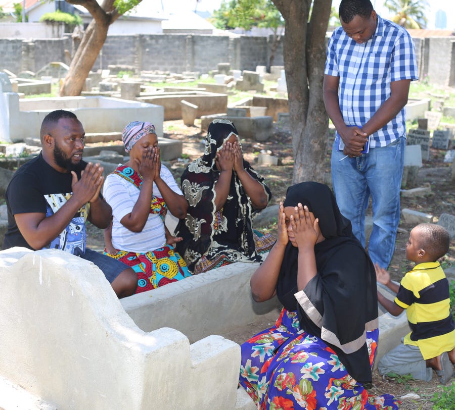 Family members of late Rabia Issa and a freelance Tanzanian reporter pray at the grave of the late Rabia at Msasani graveyard in Dar es Salaam Tanzania.