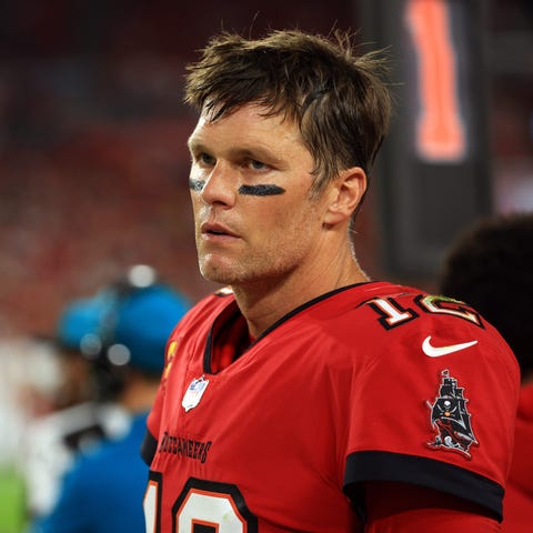 Tom Brady of the Tampa Bay Buccaneers watches from