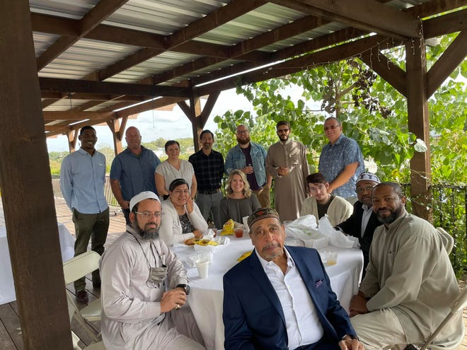 Sheikh Attia Omara, second from right in the back row, meets with religious leaders from the Austin area as part of interfaith efforts to build relationships between primarily Muslim, Christian and Jewish groups.