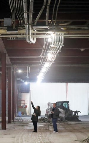 Michelle Nicholson, director of sales and leasing for Industrial Commercial Properties, shows off the remodeling that is taking place inside the old Chapel Hill Mall building.