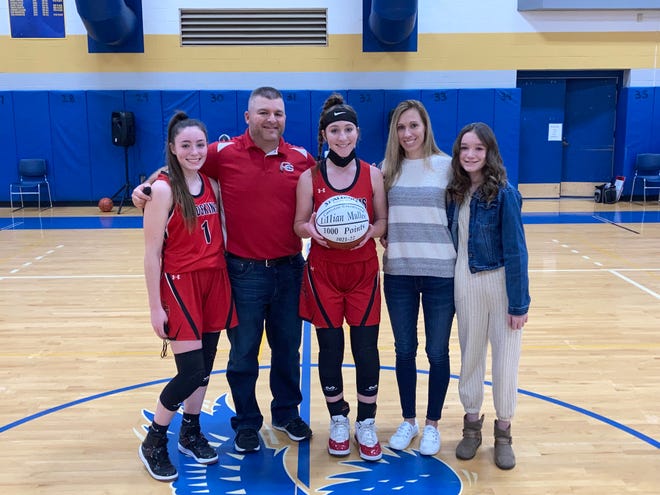 Canisteo-Greenwood's Lillian Mullen poses with her family surrounding her after scoring 1,000 points on Saturday at Alfred-Almond.