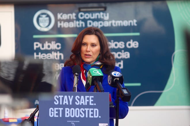 Michigan Gov. Gretchen Whitmer speaks during an update on the state's situation with the COVID-19 pandemic on Tuesday, Dec. 21, 2021, outside the Hispanic Center of West Michigan in Grand Rapids, Mich. Whitmer will propose spending $2.3 billion over four years to recruit and retain teachers and other school staff, enticing them with annual $2,000 bonuses that would grow to $4,000 by 2025.