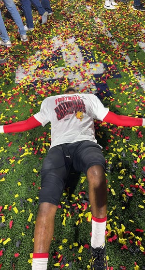 Freeport product Major Dedmond lays back onto the confetti-filled turf after helping Ferris State secure its first NCAA Division II national championship in McKinney, Texas, on Saturday, Dec. 18, 2021.
