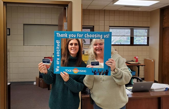 Sherri Vinston (left) and Martha Lilly (right) of Ben D. Quinn Elementary show off their $100 gift cards. The cards were gifted by Together Rising and Craven County Schools staff.