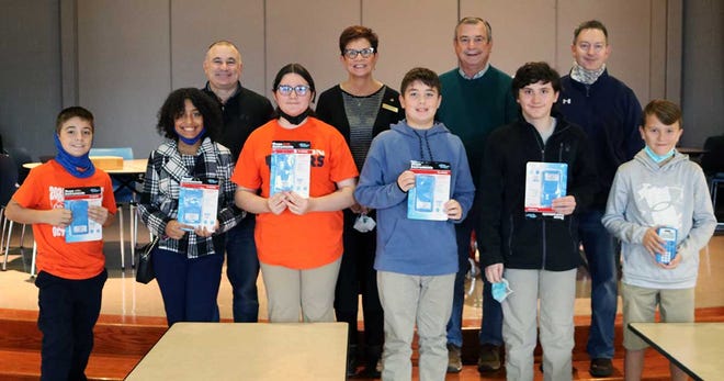 Galion Building and Loan Bank representatives Jody Fraley (back, second from left) and Stan Gregory (back, second from right) presented new calculators to all Galion Middle School sixth grade students for the 30th year in a row. Sixth-grade students pictured showing off their new calculators include (front, L to R) Ramon Hawk, Lily Hall, Summer Stephenson, Tim Miller, Ethan Craft, and Cullen Hart. GMS Principals Mr. Wheeler (back left) and Mr. Kinnard (back right) were also on hand for the presentation.