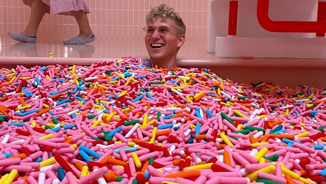 Dylan Lemay in a pool full of sprinkles.