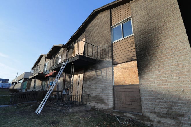 Windows and entryways are boarded up at the scene of a fatal fire at an apartment complex on South 13th Street just south of West Cleveland Avenue in Milwaukee on Tuesday, Dec. 21, 2021.