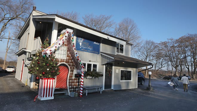 Jorge Cazzorla Elegant Designs shop is decorated like a giant gingerbread house in Pittsford Tuesday, Dec. 21, 2021. The business is located in Northfield Common Building F on Schoen Place in Pittsford.   