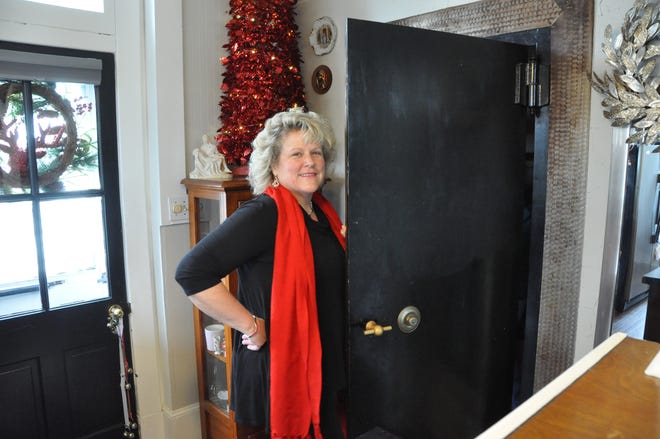 In her home on Main Street in Townsend, Maryann Coates opens the former Wilmington Trust vault, which is now a kitchen pantry.