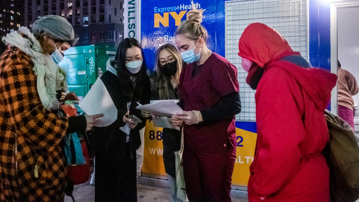 People check their rapid coronavirus test results outside a testing site on the Lower East Side of Manhattan in New York.