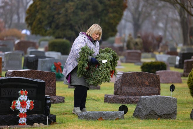 Joshua Stow Chapter of the National Society Daughters of the American Revolution member Bonnie Jabrocki lays wreaths on the graves of veterans as part of the Wreaths Across America ceremony that took place at Stow Cemetery last year.