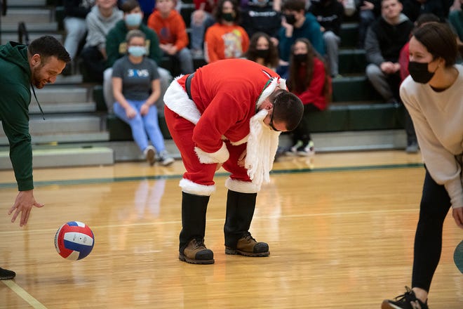 Santa Claus, also known as Blackhawk School District teacher Dan Nolte, takes a breath playing volleyball in a teachers vs. students game Tuesday at Highland Middle School.