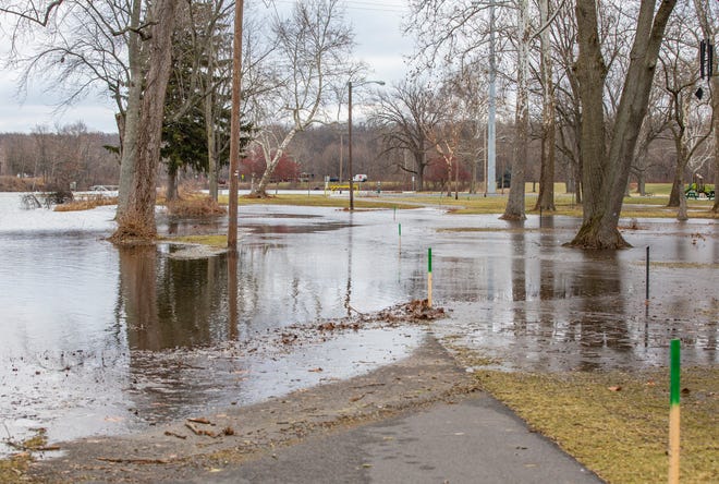 A walking path is submerged Wednesday because of the flooding of low-lying areas at Pinhook Park in South Bend.
