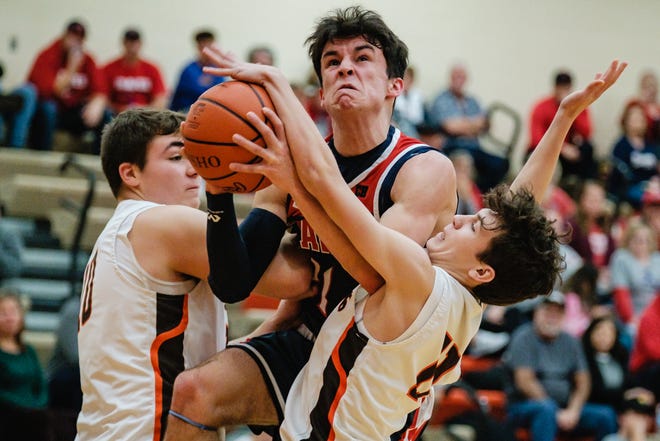Indian Valley's Tanyon McComb attempts a shot against Claymont's Dillon Watkins, left, and Matthew Jackson, right,  Tuesday night.