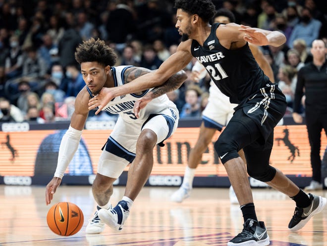 Villanova guard Justin Moore (5) is fouled by Xavier forward Jerome Hunter (21) during the first half of an NCAA college basketball game Tuesday, Dec. 21, 2021, in Villanova, Pa.