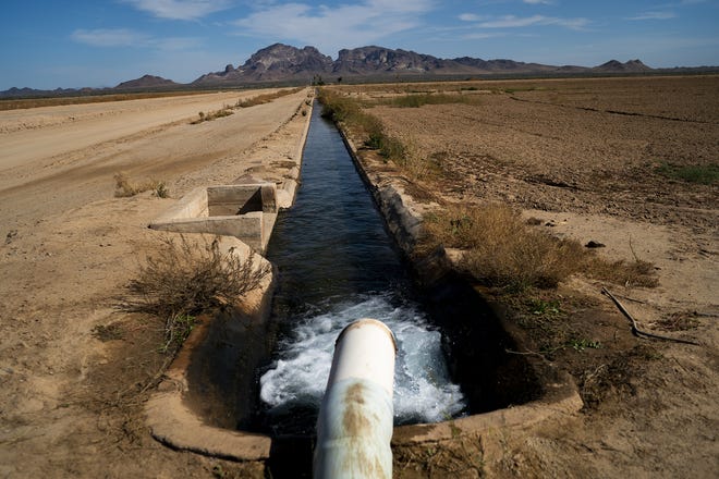 Water flows down a canal at Perry Farms on Wednesday, Oct. 20, 2021, in Tonopah.