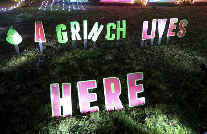 A sign embraces the Grinch mentality at the Red Lion Road home of Nino Mallari and Gloria Rivera, just up the road from the Fauchers' over-the-top holiday light display.