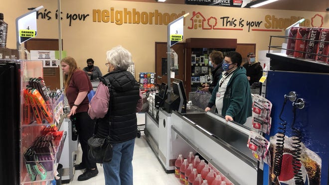 Cashiers help customers navigate the self-checkout lanes at the ShopRite in Four Seasons Plaza in Glasgow on Dec. 21, 2021.