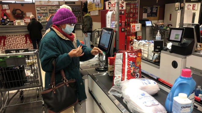 A customer uses a self-checkout aisle at ShopRite of Newark off Route 4 on Dec. 21, 2021.