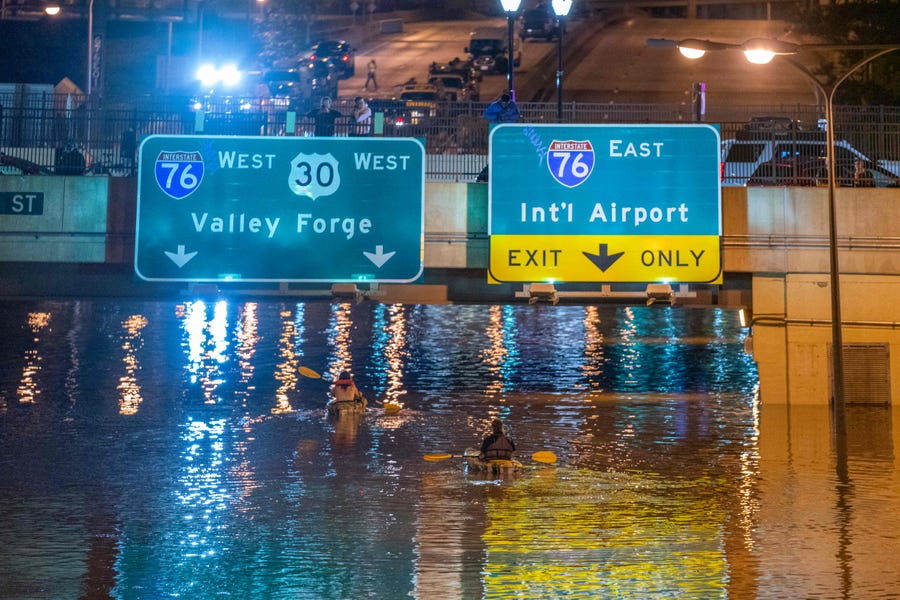 Kayakers paddle down a portion of Interstate 676 after flooding from heavy rains from hurricane Ida in Philadelphia, Pennsylvania on September 2, 2021. Flash flooding caused by the remnants of Hurricane Ida killed at least 44 people in four northeastern US states one night, including several who perished in basements during the historic weather event officials blamed on climate change.