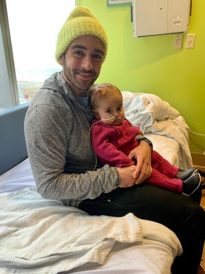 Andrew Kaczynski holds his daughter, Francesca. He's made it his mission to raise money for pediatric cancer research in his daughter's name.