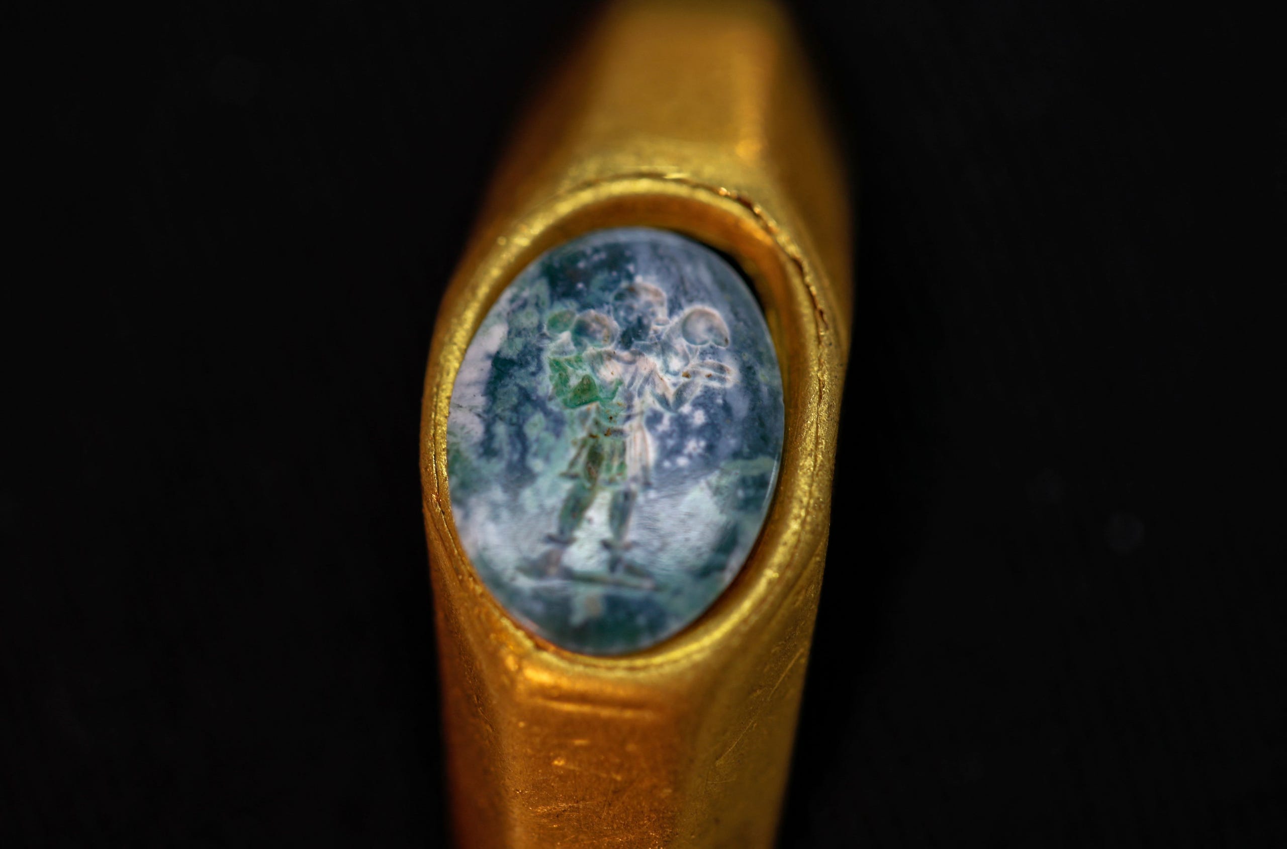 A gold ring carrying a green stone engraved with the figure of the Good Shepherd, one of the earliest expressions to refer to Jesus, is displayed at the Israeli Antiquities Authority lab in Jerusalem on December 22, 2021.