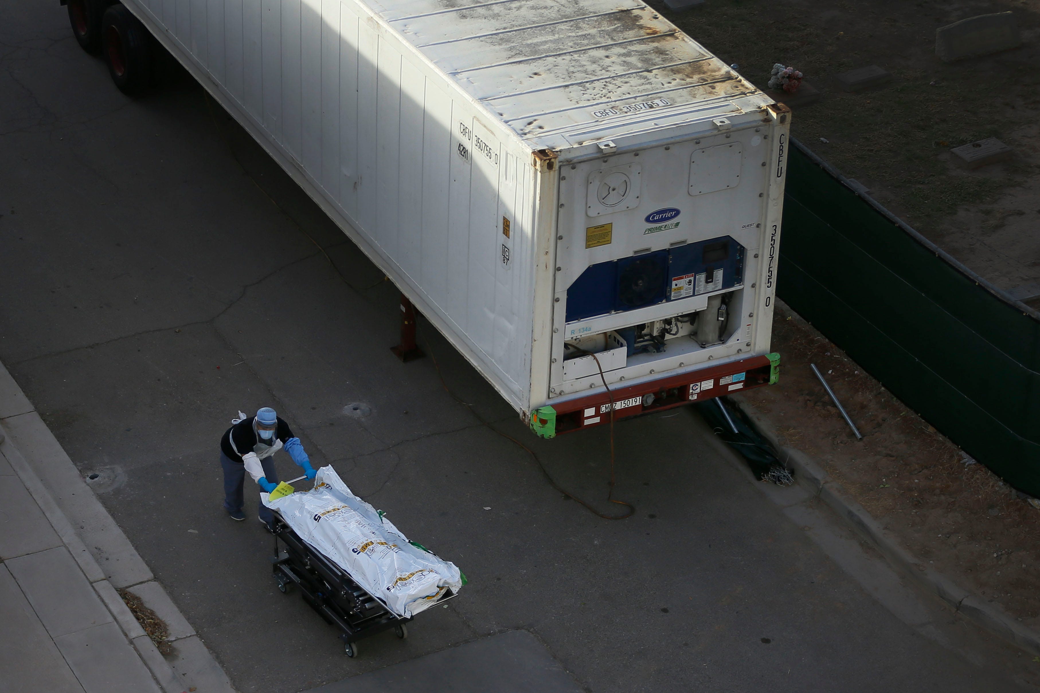 Medical workers use mobile morgues near the El Paso Medical Examiner on Nov. 9, 2020, as coronavirus cases spike in El Paso, Texas.